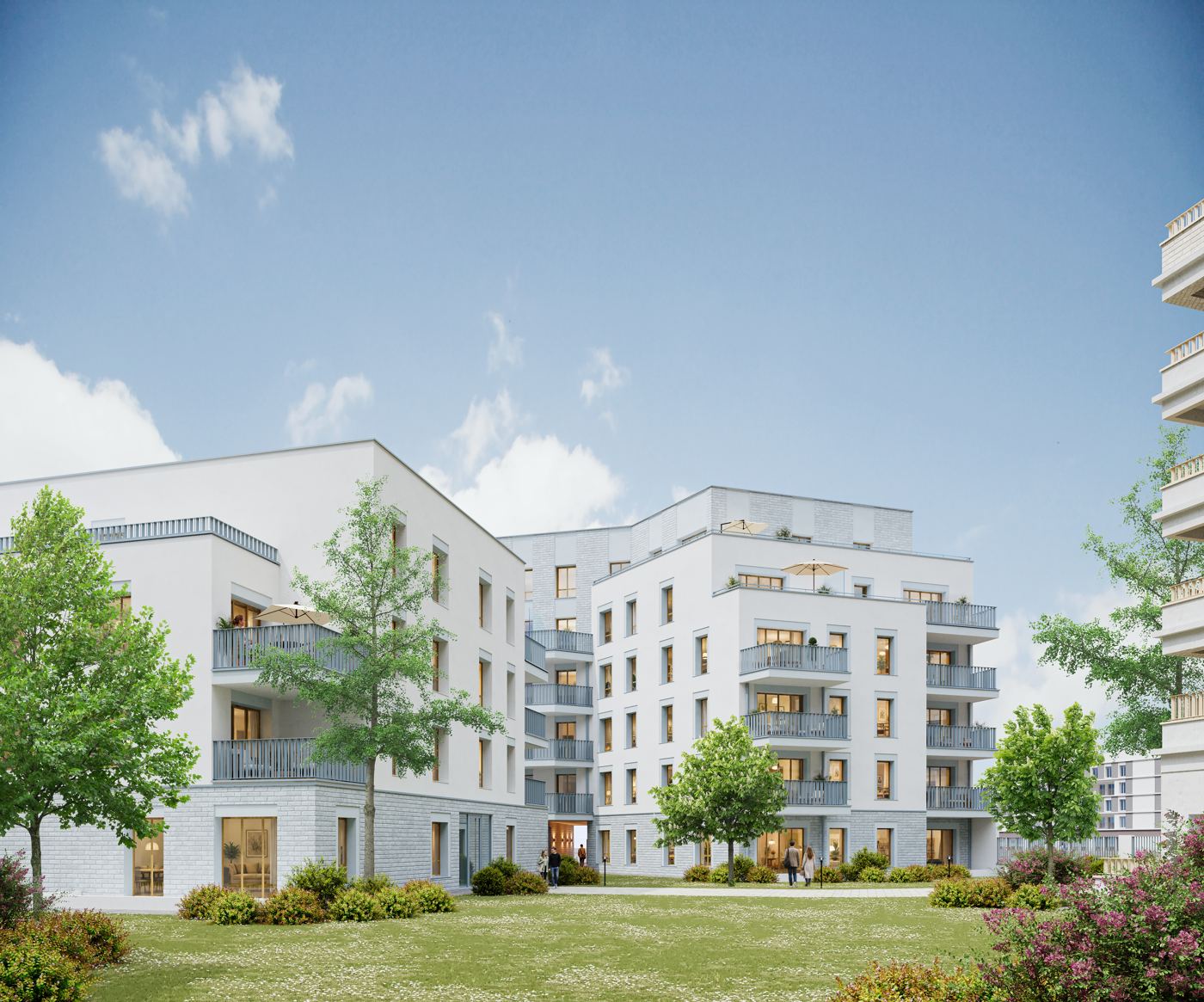 Le jardin paysager au cœur de la résidence BRIQ, entouré des façades blanches et gris bleu